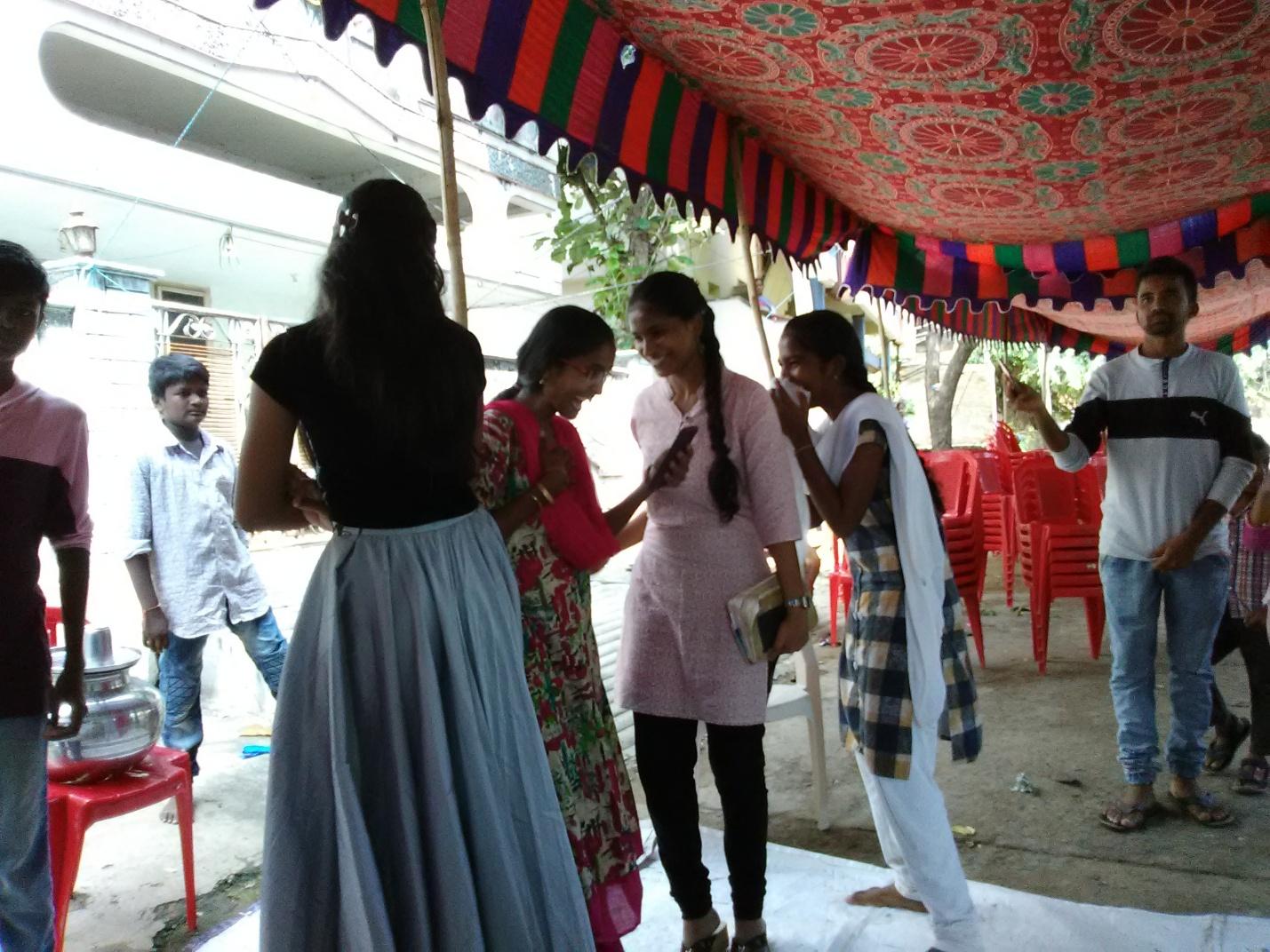 Some girls chatting in the “street church” after the sermon.