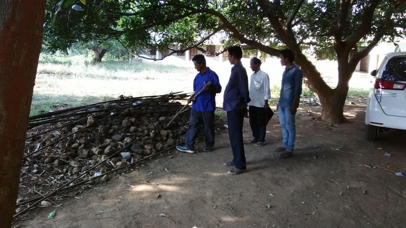 Some of the pastors trying to get a snake out of its nest at the orphanage