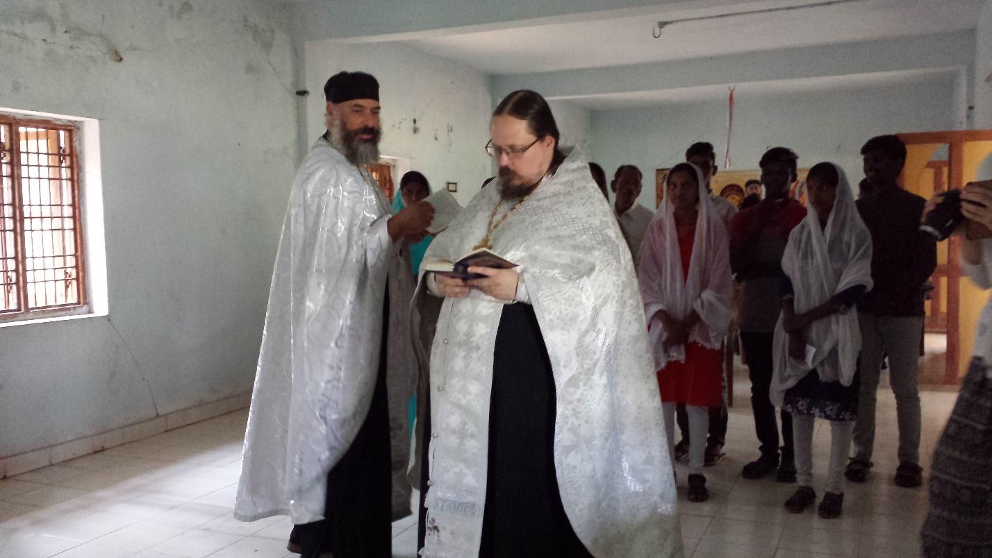 Fr. Athanasius and Fr. George preparing a group for baptism inside the orphanage