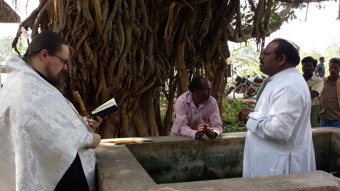 Fr. George with Joshi-Paul in the baptismal font